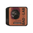A rectangular tin of Bad Lab Jet Black Water-Based Pomade, featuring a black eagle graphic on a terracotta background with a black lid, set against a plain white background.