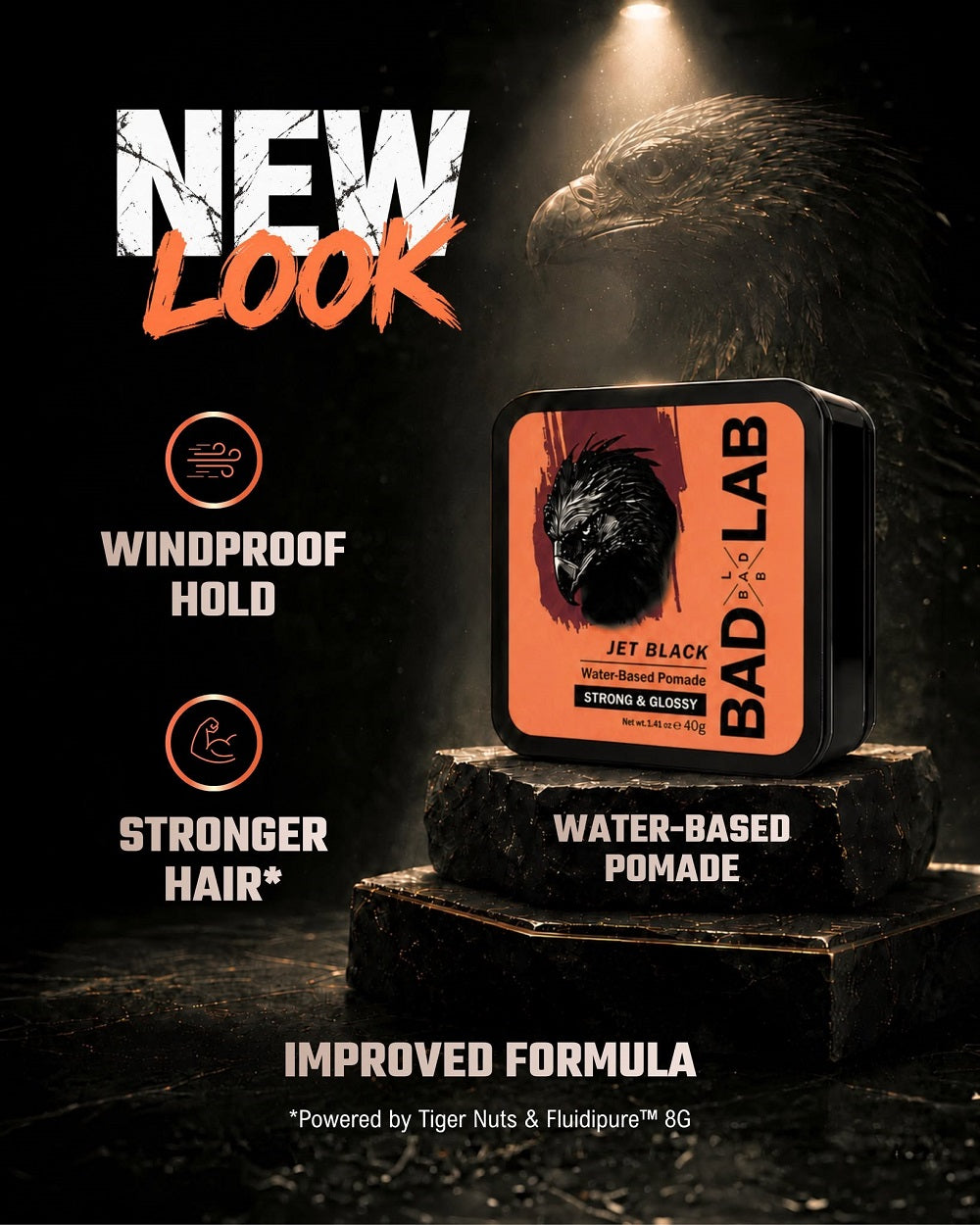 A tin of BAD LAB Jet Black Water Based Pomade displayed on stacked dark stone blocks, with dramatic lighting and a dark textured background. Text on the image highlights 'NEW LOOK', 'WINDPROOF HOLD', 'STRONGER HAIR*', and 'IMPROVED FORMULA'.