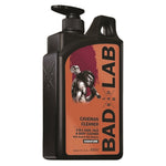 A 800ml black plastic pump bottle of Bad Lab Cavernian Cleaner, featuring a prominent orange and burgundy label with a caveman graphic.