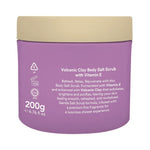 Purple jar of volcanic clay body salt scrub with beige lid on a white background